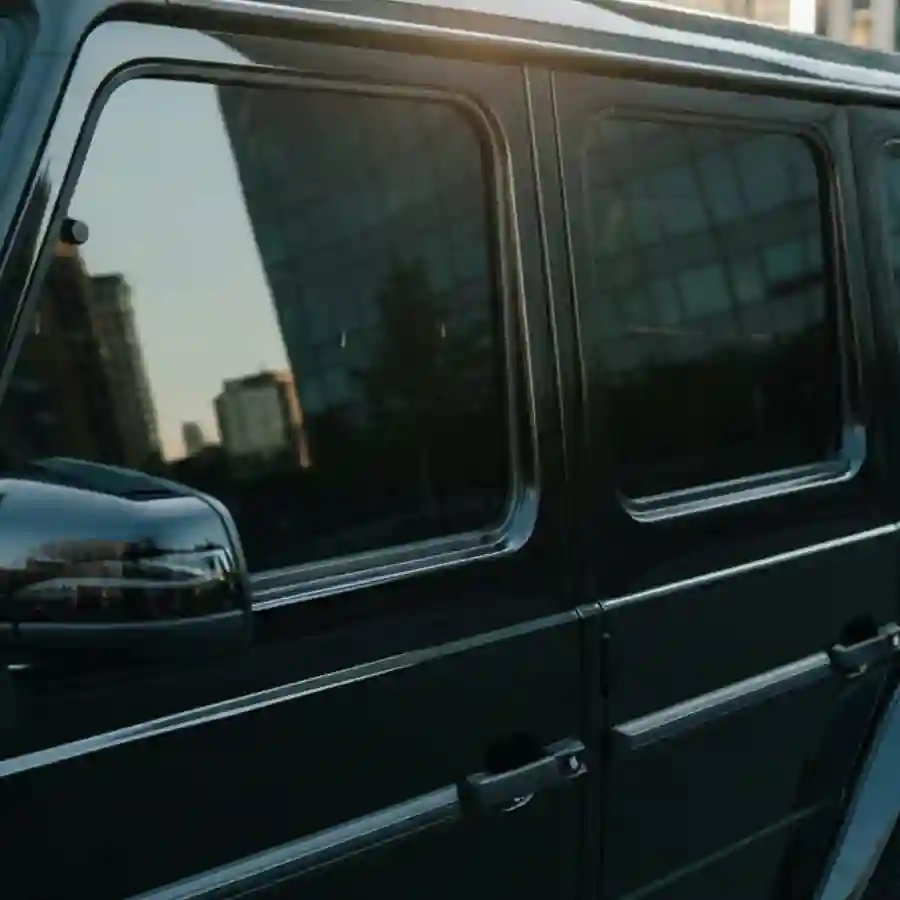 Mercedes G-Wagon G550 limousine with ceramic tint, showcasing sleek black exterior and urban backdrop, emphasizing luxury customization options.