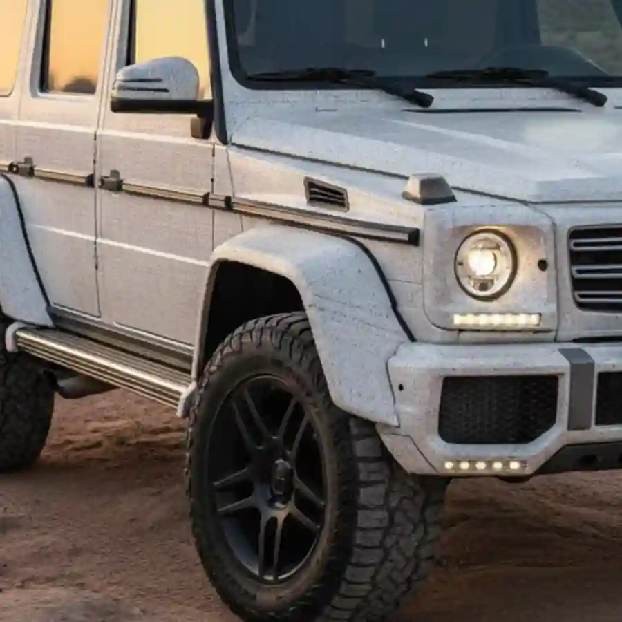 Mercedes G-Wagon G550 in white with rugged tires, showcasing luxury features and off-road capabilities, relevant to Big Limos' customization options.