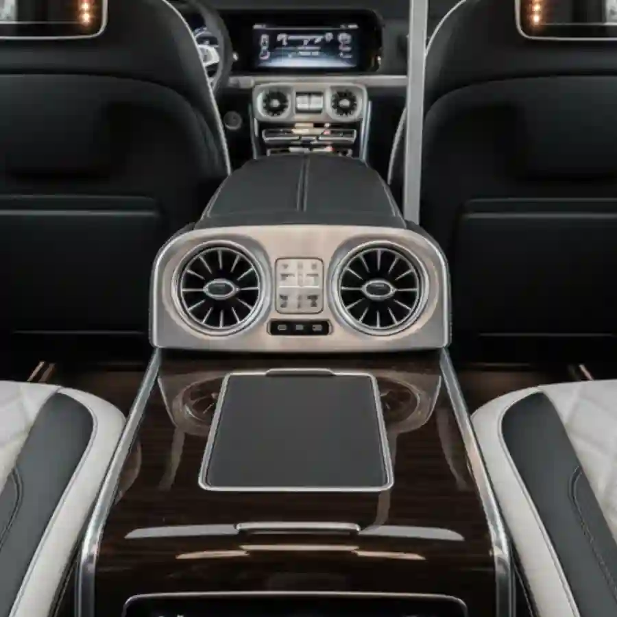 Luxury interior of a Mercedes G-Wagon G550 limousine featuring sleek air vents, advanced control panel, and premium seating, highlighting customization options for luxury vehicle buyers.