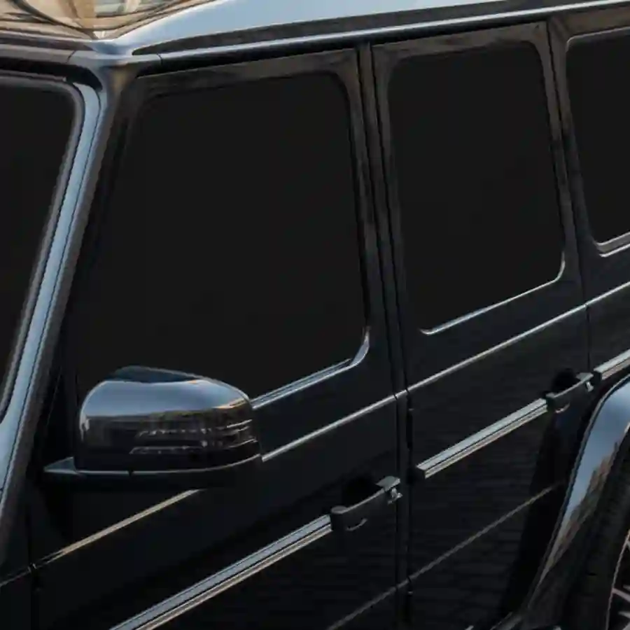 Mercedes G-Wagon G550 limousine side view with privacy shades, highlighting sleek design and luxury features for customization.