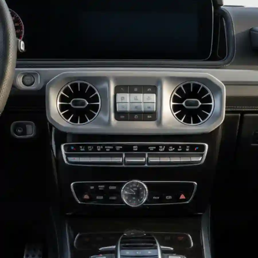 Luxury interior dashboard of a Mercedes G-Wagon G550, featuring climate control vents, multimedia interface, and sleek design elements, relevant to the customization options for the limousine configurator by Big Limos.