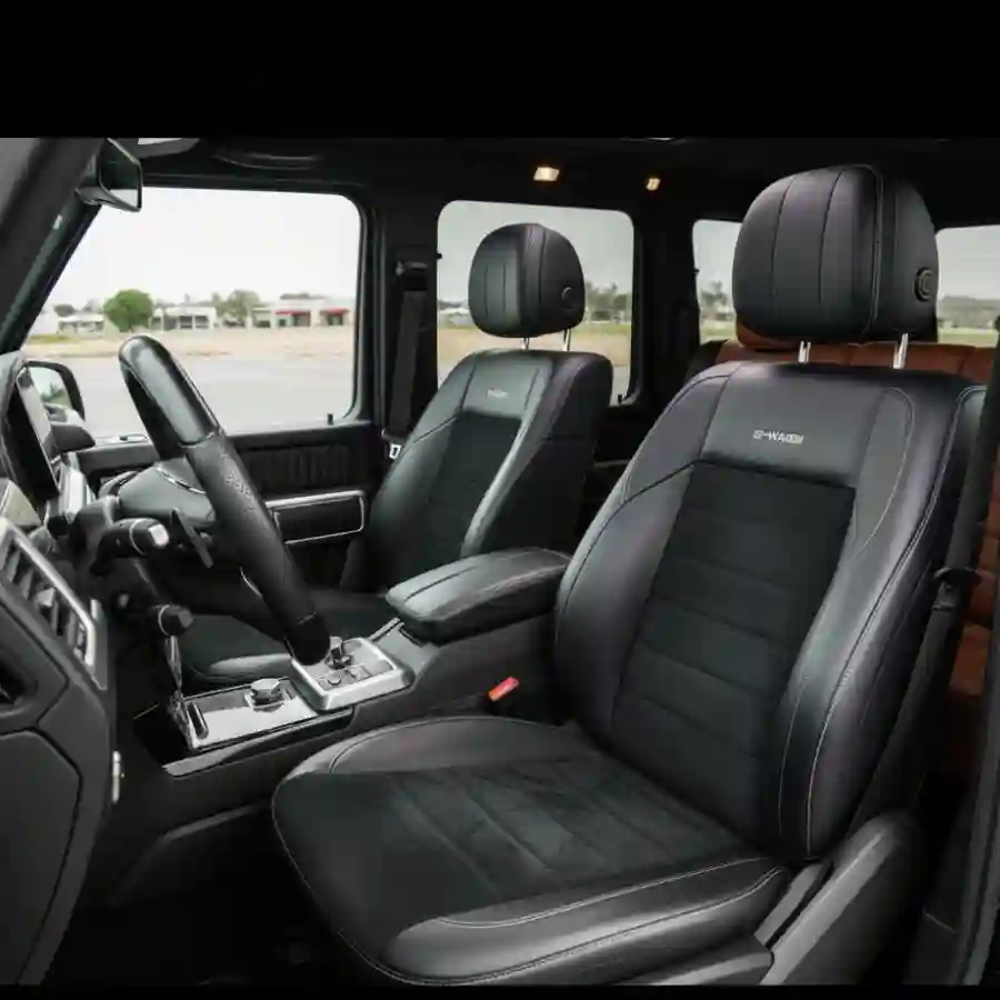 Luxury interior of a Mercedes G-Wagon G550, featuring premium black leather seats, a stylish dashboard, and advanced controls, highlighting customization options for Big Limos' limousine configurator.