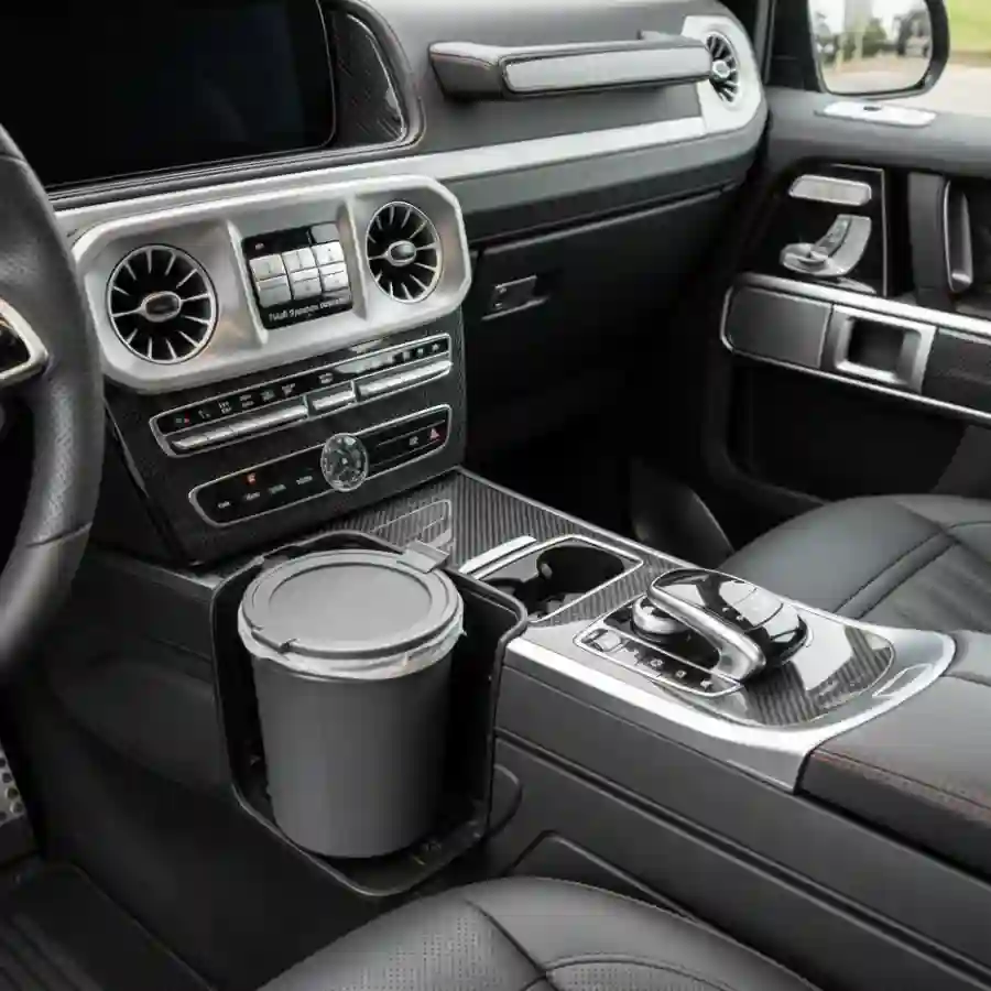 Interior view of Mercedes G-Wagon G63 dashboard featuring luxury controls, air vents, and cup holder, highlighting customization options for Big Limos luxury limousine configurator.